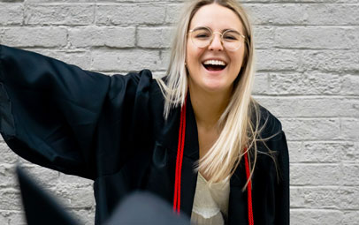En high school-student har precis kastat sin hatt upp i luften.